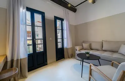a living room with a couch and a table at Incentra in Chania Town