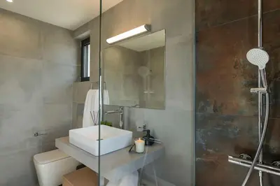 a bathroom with a sink and a shower at Villa Thea, stunning view, pool, BBQ, Brand new. in Kissamos