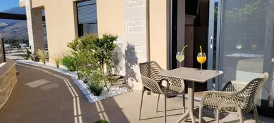 a patio with a table and chairs on a balcony at Splendid Villas and Family Resort in Kalamitsi Amygdali