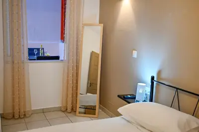 a bedroom with a bed and a mirror at Artemis No.2 Apartment in Kissamos