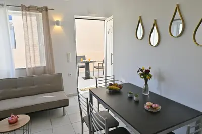 a living room with a table and a couch at Artemis No.2 Apartment in Kissamos