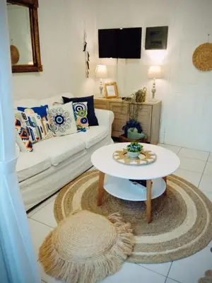a living room with a white couch and a table at Kaldora Apartment in Chania Town