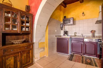 a kitchen with purple cabinets and a sink at Samonas - Red villa Fliskouni in Chania Town