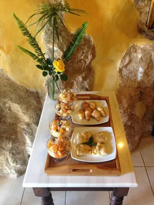 a table with three trays of food on it at Samonas - Red villa Fliskouni in Chania Town