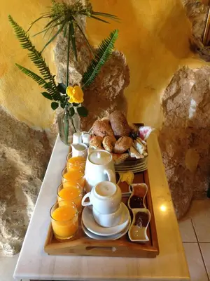 a tray with cups of tea and oranges on a table at Samonas - Red villa Fliskouni in Chania Town