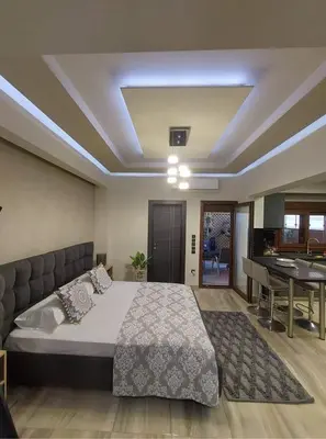 a bedroom with a large bed and a dining room at Rika’s Luxury seaside apartment in Chania Town