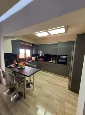 a kitchen with a table and chairs in a room at Rika’s Luxury seaside apartment in Chania Town