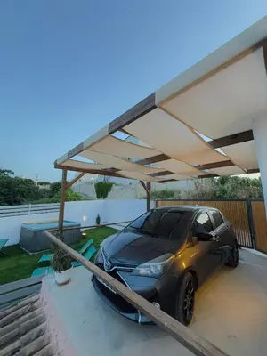 a car is parked under a cover on a house at Remvi Suite in Chania in Xamoudhokhórion