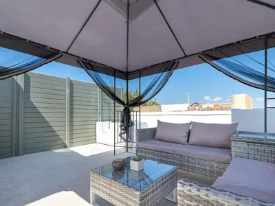a patio with a couch and a table at Metropolitan Pearl Boutique Hotel in Chania Town