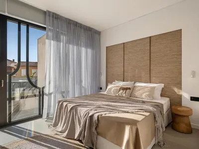 a bedroom with a large bed and a large window at JnV Luxury Villas in Chania Town