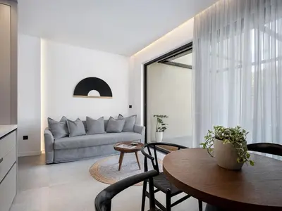 a living room with a couch and a table at JnV Luxury Villas in Chania Town