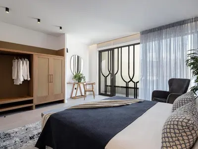 a bedroom with a bed and a large window at JnV Luxury Villas in Chania Town