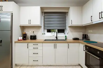a kitchen with white cabinets and a sink at Kares Dream House in Chania Town