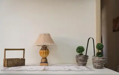 a table with three potted plants and a lamp on it at Dominic Chania 3 Room Apartment in Chania Town