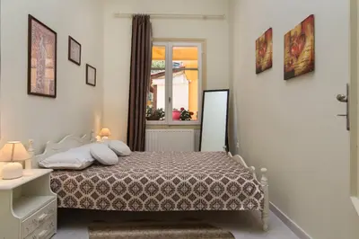 a bedroom with a bed and a window at Dominic Chania 3 Room Apartment in Chania Town