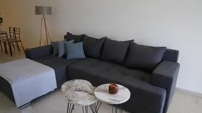 a living room with a couch and a table at KM Beach View apartment in Chania Town