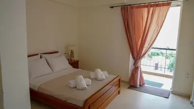 a bedroom with a bed with towels on it at KM Beach View apartment in Chania Town