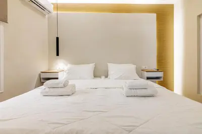 a bedroom with a large white bed with two night stands at Stef&Art Old Town House in Chania Town