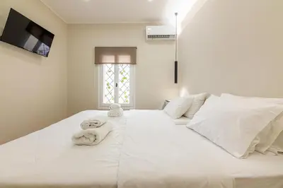 a bedroom with a white bed with towels on it at Stef&Art Old Town House in Chania Town