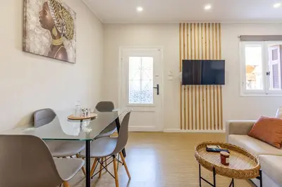 a living room with a table and a couch at Stef&Art Old Town House in Chania Town