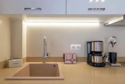 a kitchen counter with a sink and a coffee maker at Vakakis Family Luxury Studios 2 in Palaiochóra