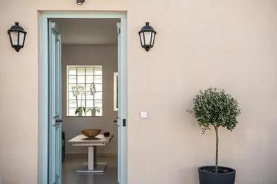 a hallway with a table and a potted plant at Mythodea Luxury Suites in Chania Town