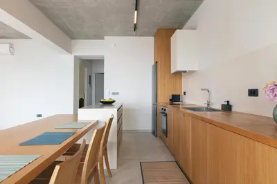 a kitchen with a long wooden table and a counter at Krystallon Villas in Palaiochóra
