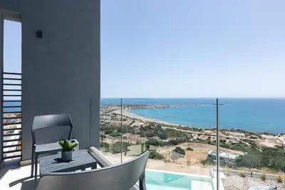a room with a view of the ocean at Krystallon Villas in Palaiochóra