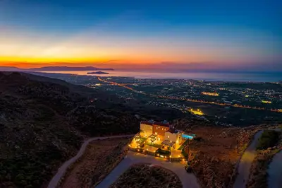 an aerial view of a city at sunset at Villa Lia Chania with private ecologic pool and amazing view! in Chania Town