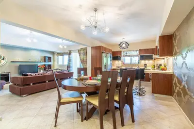 a kitchen and living room with a table and chairs at Elena Apartment in Chania Town