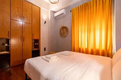 a bedroom with a bed with two towels on it at Mimosa Urban Habitation in Chania Town