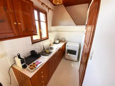 a small kitchen with a sink and a stove at Dusk Apartments with Stunning Mountain View in Chania Town