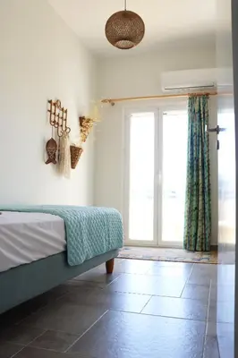 a bedroom with a bed and a large window at Cassandra's Haven in Kissamos