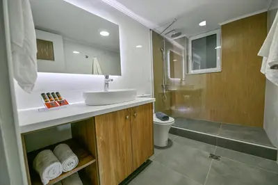 a white bathroom with a sink and a shower at Blue Horizon Kisamos Deluxe Apartment in Kissamos