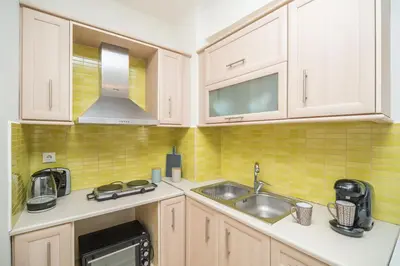 a kitchen with a sink and a microwave at MYRTIA APARTMENT few steps from the sea in Chania Town