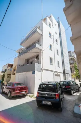 two cars parked in front of a building at MYRTIA APARTMENT few steps from the sea in Chania Town