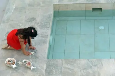 a woman laying on the floor playing with star balloons at VILLA BLUE VEDERE in Gerani Chanion