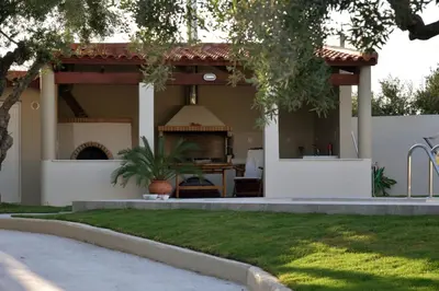 a house with a porch and a patio at VILLA BLUE VEDERE in Gerani Chanion