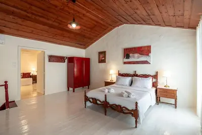 a bedroom with a large bed with a wooden ceiling at Casa Lion in Chania Town