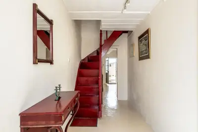 a hallway with a red staircase with a red stair case at Casa Lion in Chania Town