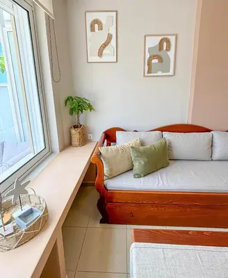 a living room with a couch and a window at Vista Mare in Palaiochóra