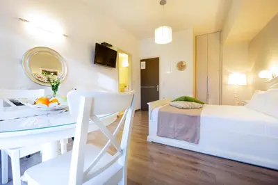 a bedroom with a bed and a table with a mirror at Casa Del Porto in Chania Town