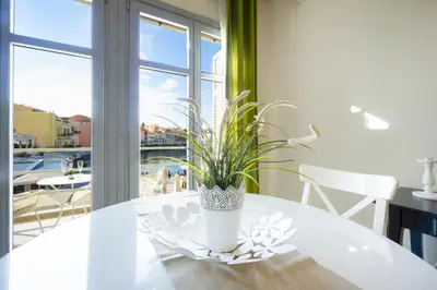 a white dining room table with a plant on it at Casa Del Porto in Chania Town