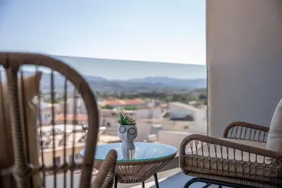a table with a pineapple on top of it on a balcony at Almy Luxury Apartments in Chania Town
