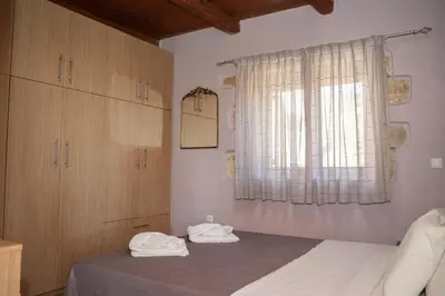 a bedroom with a bed with two towels on it at SundayMar Stone House in Chania Town