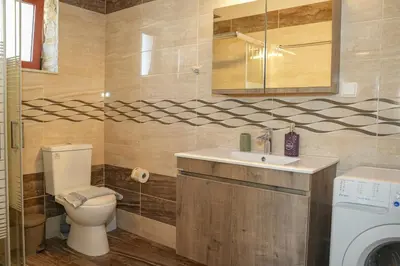 a bathroom with a toilet and a sink and a mirror at SundayMar Stone House in Chania Town