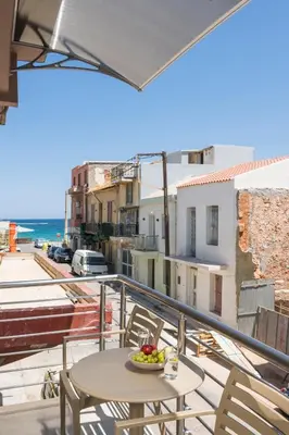 a balcony with a table and a bowl of fruit at Crescendo City House in Chania Town