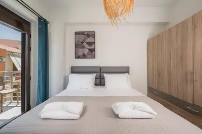 a bedroom with a bed with two white pillows at Crescendo City House in Chania Town