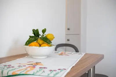 a bowl of lemons sitting on a table at Manos Home in Spiliá