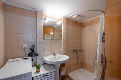 a bathroom with a sink and a toilet and a shower at Manos Home in Spiliá